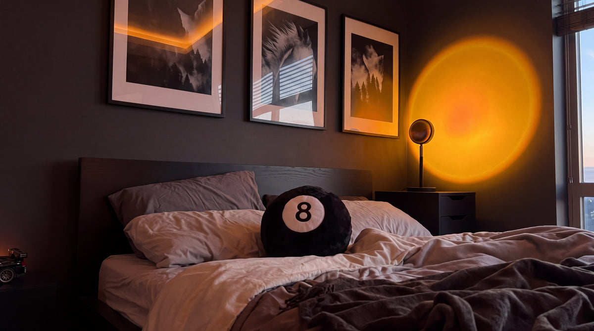 A round 8 ball pillow on a low dark bed